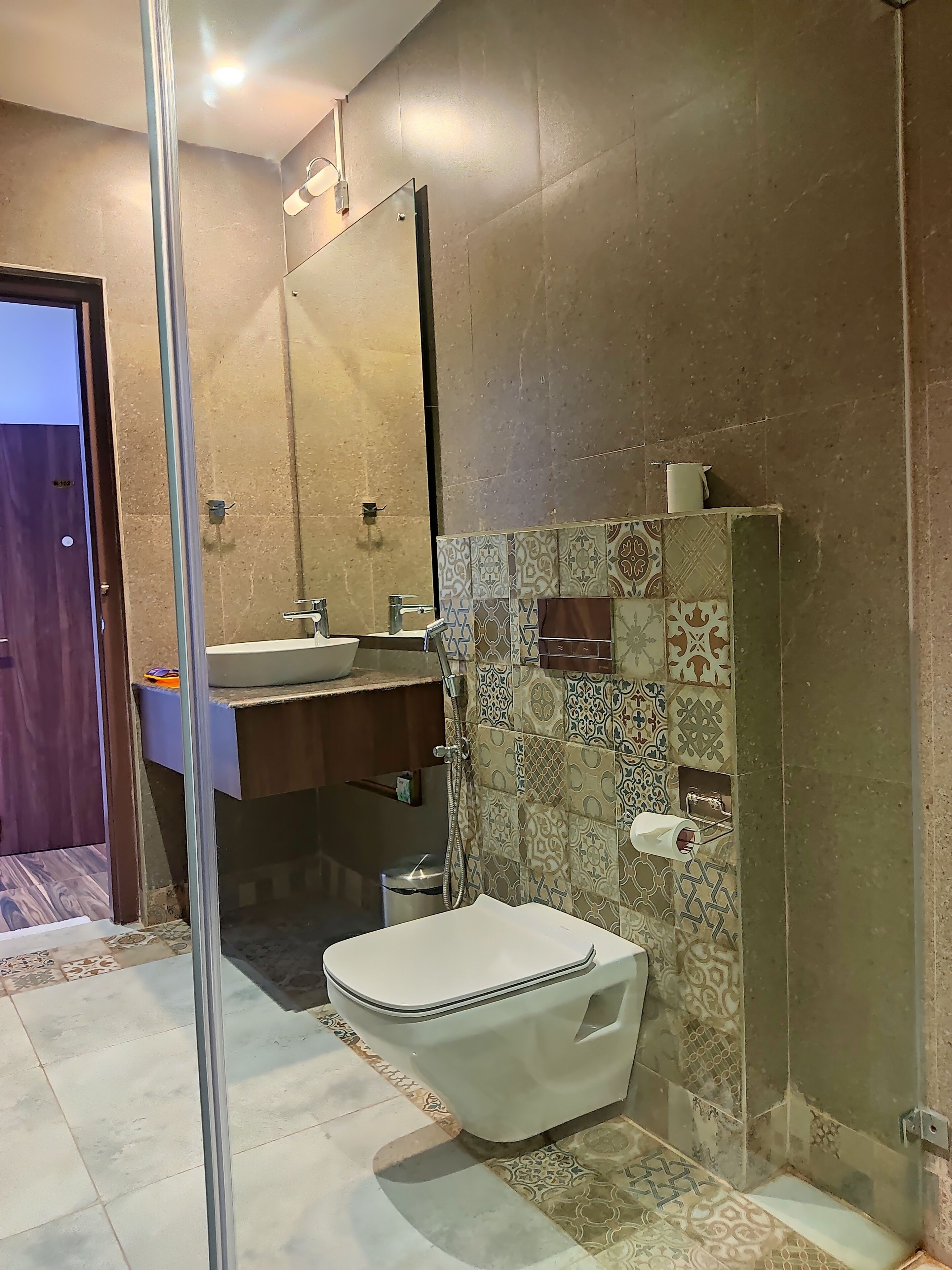 A bathroom with a toilet, sink, and shower.