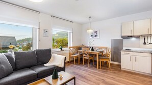A modern apartment with a living area, dining space, and kitchen.