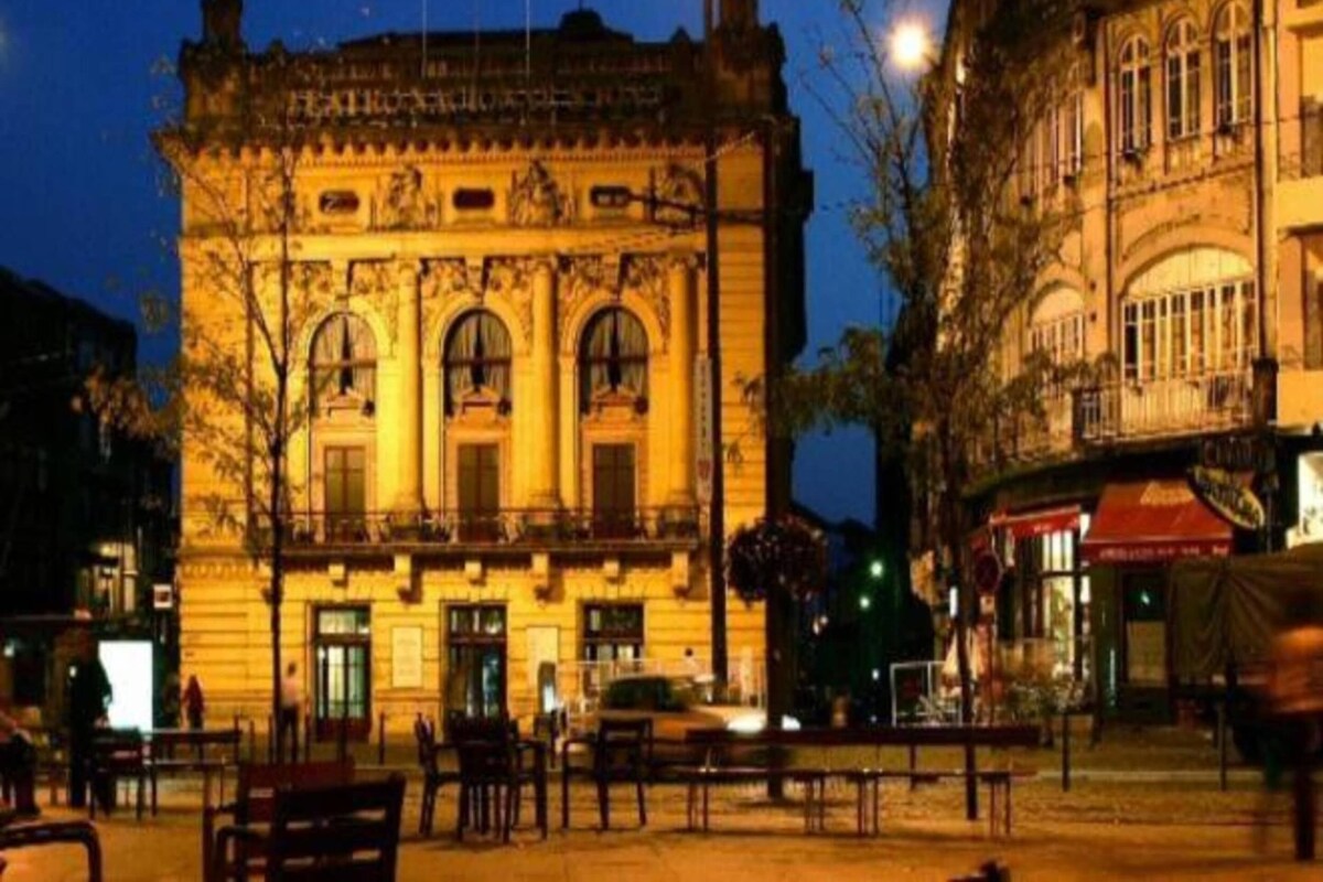 A historic building with classical architecture, featuring arched windows and a central entrance.