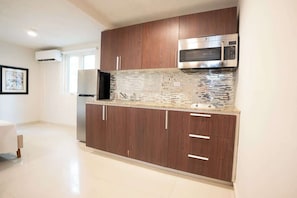 Microwave, stovetop, cookware/dishes/utensils, dining table