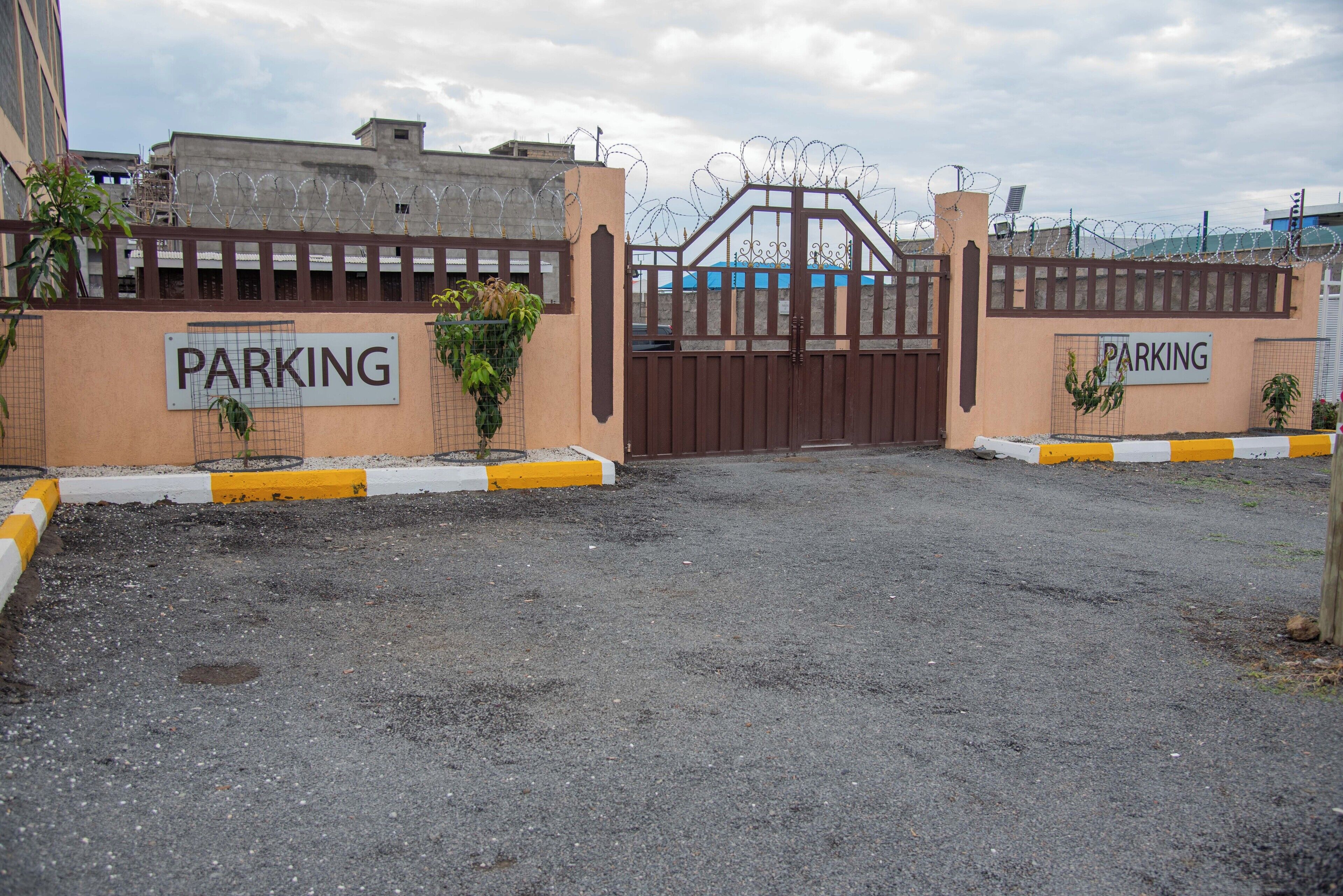 A gated parking area with a sign indicating "PARKING".