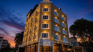 A multi-story hotel building with a sign indicating it is the Mandovin Rest & Hotel. - Hotel Mandovin - A Premium Hotel In Udaipur (Udaipur)
