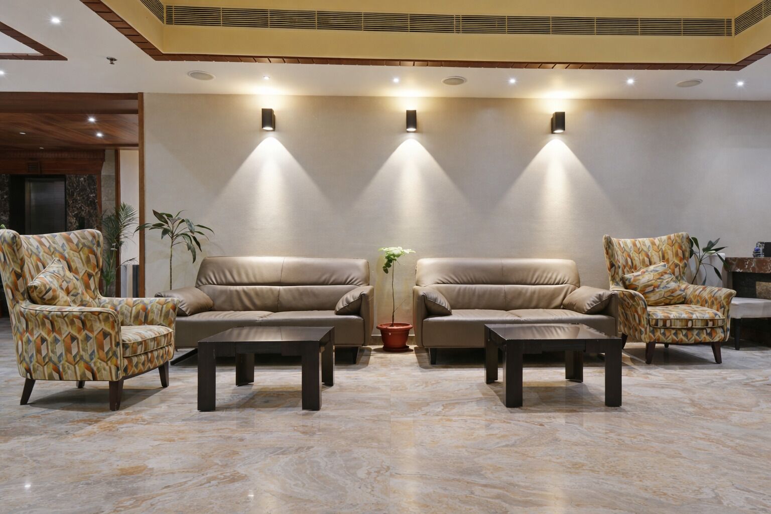 A lobby with two sofas, two armchairs, and two coffee tables.