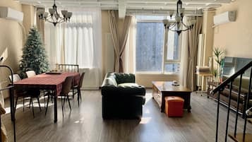 Family Apartment, City View | Living area | 42-cm Smart TV with cable channels