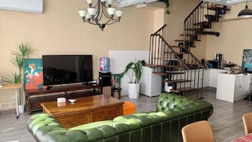 Family Apartment, City View | Living area | 42-cm Smart TV with cable channels