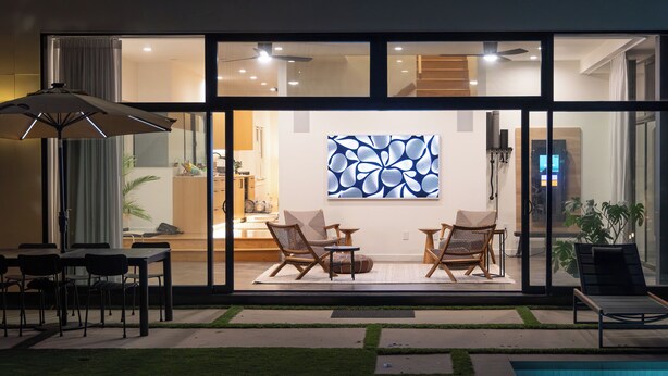A modern outdoor patio with a pool, lounge chairs, and a dining area with a table and chairs. - Private wellness home with pool, sauna, & cold plunge - in the center of Venice. (Los Angeles)