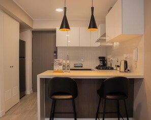 Fridge, microwave, stovetop, coffee/tea maker