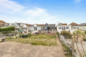 A row of modern houses with a mix of architectural styles, including gabled roofs and large windows.