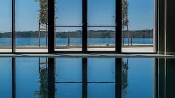 Indoor pool, open 9:00 AM to 9:00 PM, pool loungers