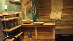 Een gezellige keuken met een gasfornuis, waterkoker en houten planken.