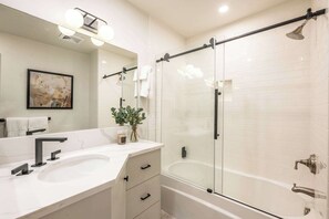 Shower, hair dryer, towels, shampoo