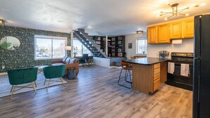 A spacious kitchen with wooden cabinets, a black refrigerator, and a wooden island. - Lone Peak View | Pickleball + Putting Green (Draper)