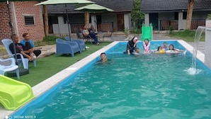 A swimming pool with a water slide and a small waterfall feature. - Desa Retreat Kuala Kangsar (Kuala Kangsar)