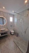 Superior Suite, Balcony, Sea View | Bathroom | Shower, hair dryer, slippers, towels