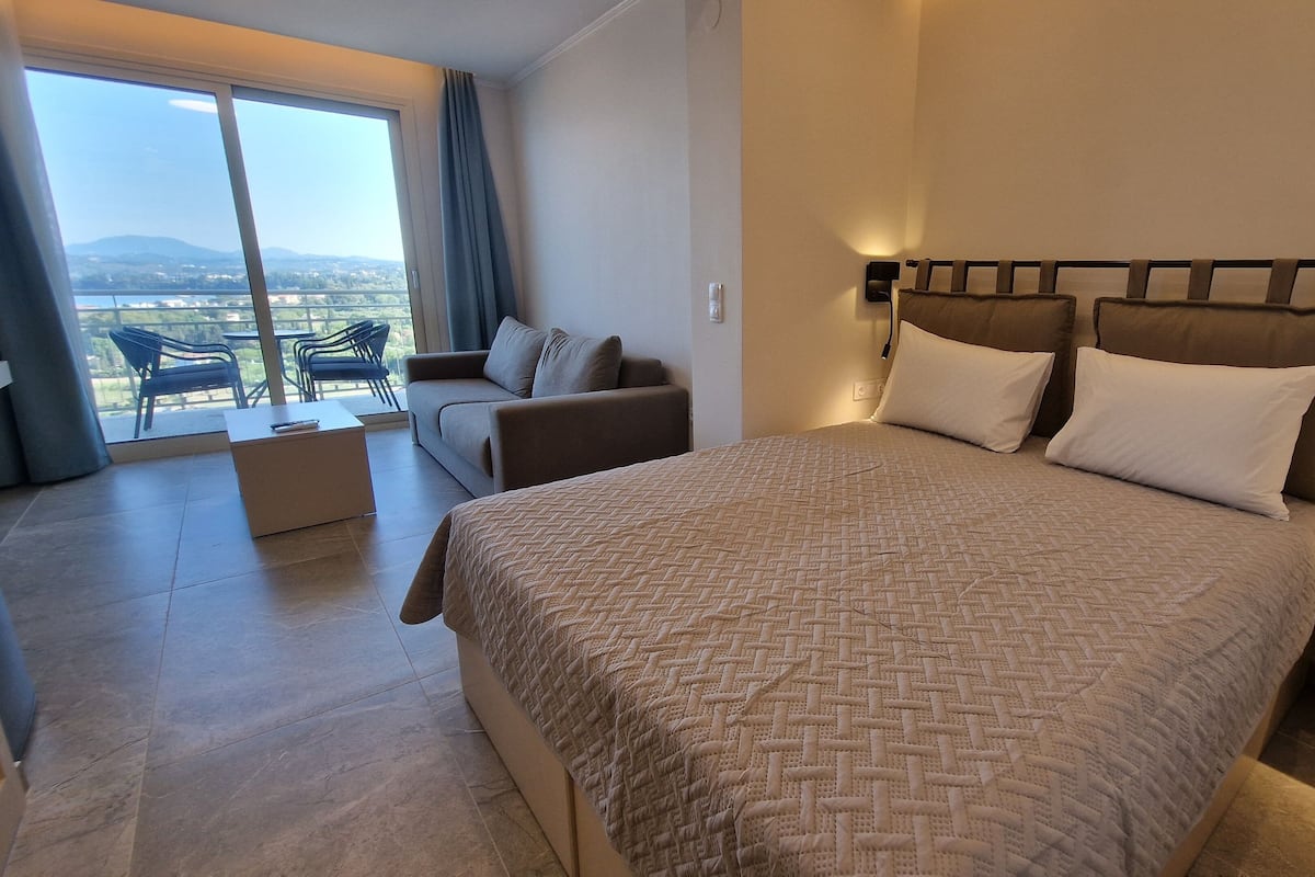 Junior Suite, Balcony, Sea View | Desk, laptop workspace, blackout drapes, iron/ironing board