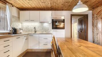 Deluxe Chalet, Mountain View | Private kitchen | Toaster, highchair, dining tables