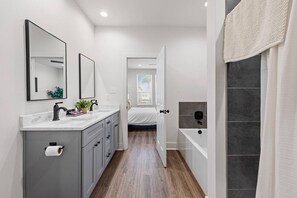 A modern bathroom with a shower, a toilet, and a sink. - NEW•Voodoo House•KING Bed• (Lafayette)