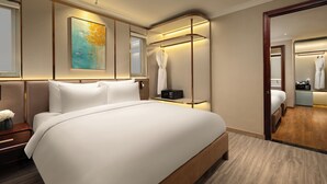 A modern hotel room with a large bed, a bedside table, a mirror, and a wardrobe. - Splendid Secret Hotel (Hanoi)