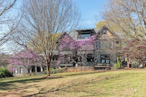A large, historic stone building with a prominent entrance and a well-maintained lawn. - Abode Sauvage (Atlanta)