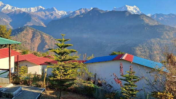 A mountainous landscape with snow-capped peaks in the background.