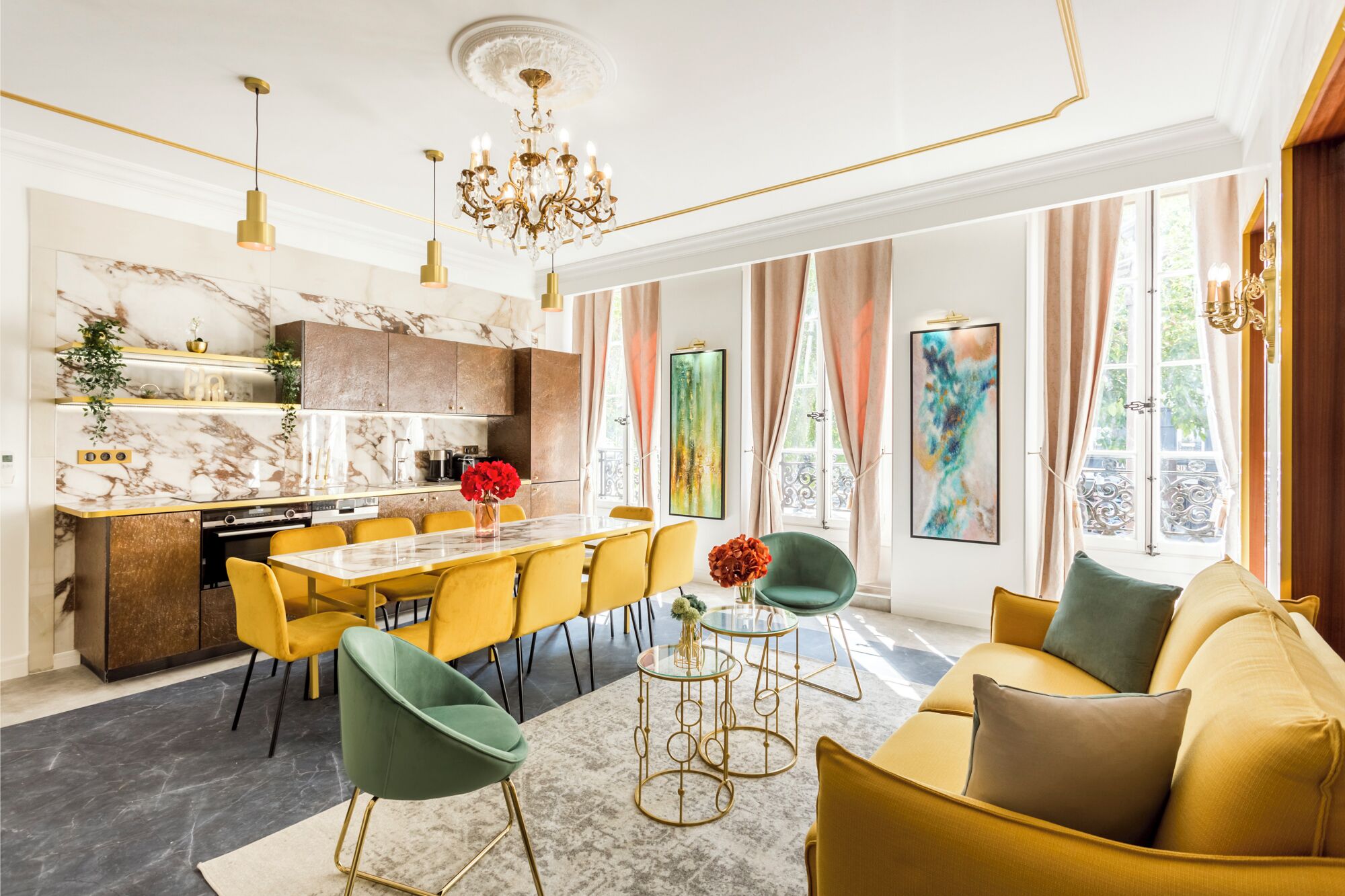 Ein modernes Wohnzimmer mit einem gelben Sofa, grünen Sesseln, einer Marmorküche und großen Fenstern mit Vorhängen.