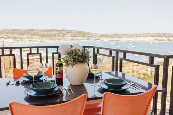 Outdoor dining - Beautiful seafront apartment in Għadira Bay with 2 bedrooms, 2 bathrooms, and a large terrace offering breathtaking sea views. Located on the second floor (no lift) and just 1 minute from the sandy beach — ideal for a relaxing seaside escape. (Il-Mellieħa)
