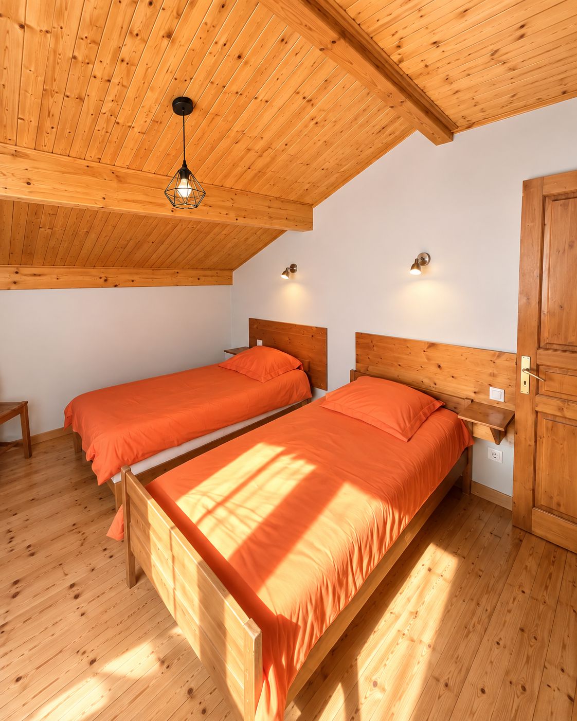 A room with two wooden beds, a wooden ceiling, and a wooden wardrobe.