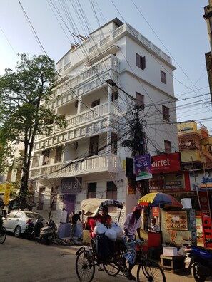 A multi-story building with balconies, a visible sign for 'hotel 21', and a 'HOTTEL' sign on the ground floor. - Hotel 21 (Kolkata)