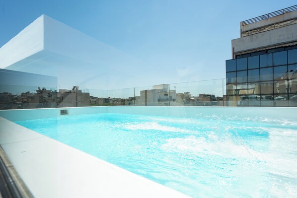 Seasonal outdoor pool, open 8:00 AM to 8:00 PM, pool umbrellas
