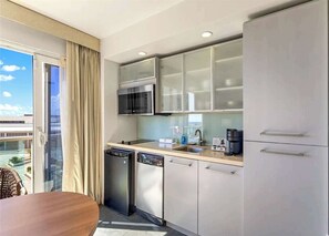 Fridge, microwave, coffee/tea maker, cookware/dishes/utensils