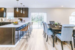 Fridge, stovetop, cookware/dishes/utensils, dining tables