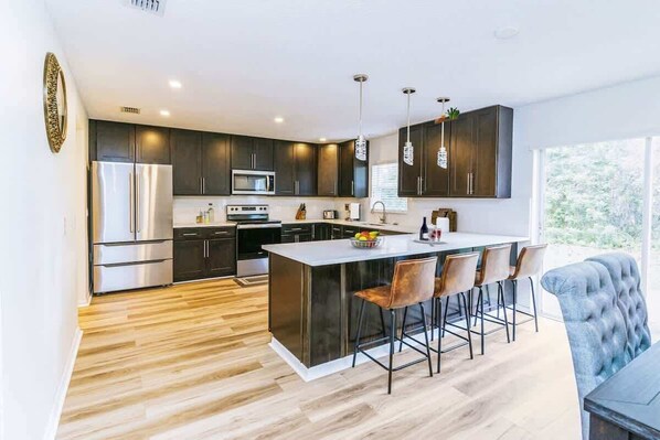 Fridge, stovetop, cookware/dishes/utensils, dining tables