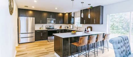 Fridge, stovetop, electric kettle, cookware/dishes/utensils