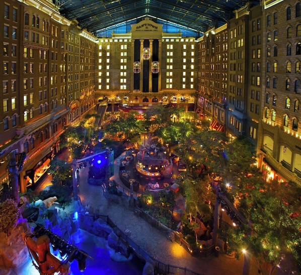 A hotel lobby with a central fountain, multiple floors, and a large atrium. - Private Pool Retreat 3BR Las Vegas Home (Las Vegas)