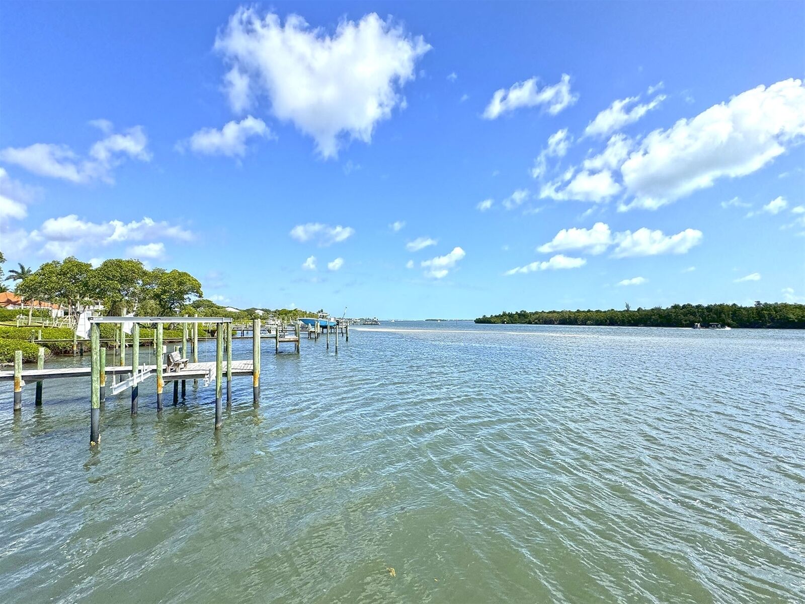A waterfront dock with a clear view of the water and a distant island.
