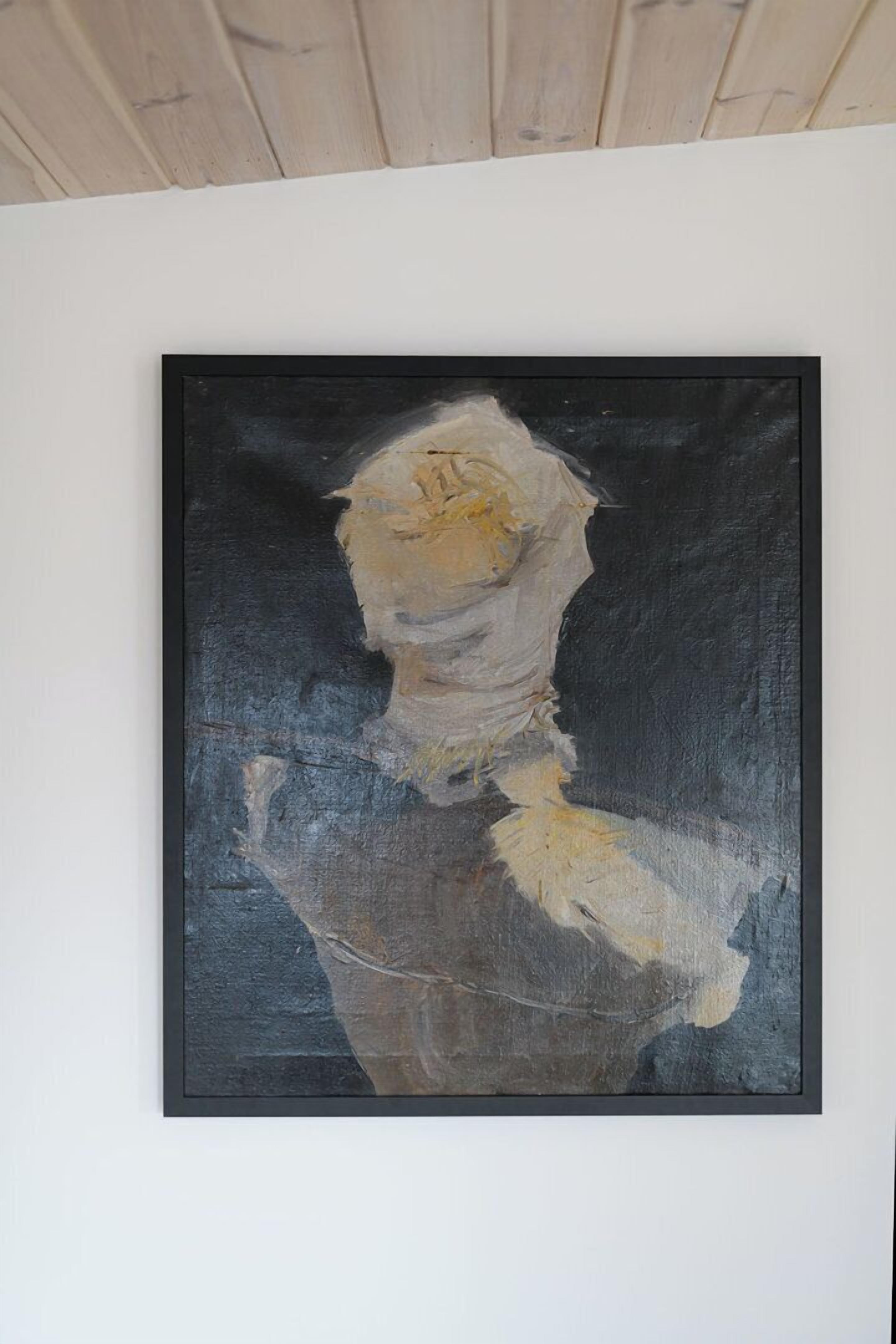 A framed abstract painting on a white wall.