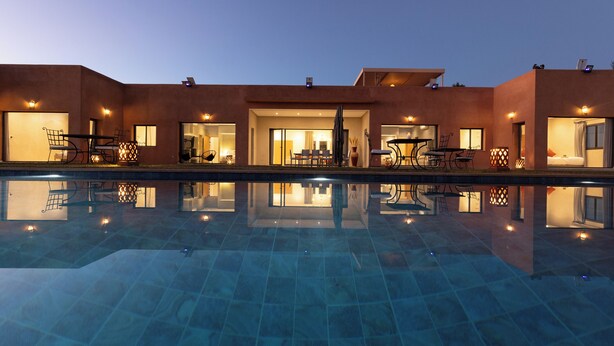 Un bâtiment moderne avec une piscine devant.