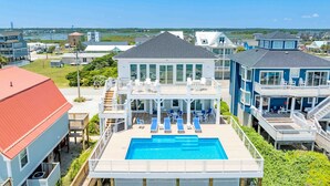 A coastal property with a swimming pool, multiple decks, and a view of the ocean. - Ziggy's Place - New Luxury 8 BR Oceanfront Home; Pool & Elevator! (Surf City)
