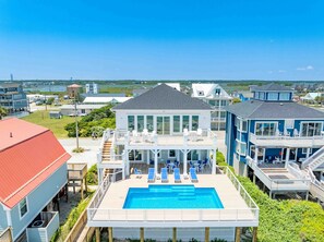 A coastal property with a swimming pool, multiple decks, and a view of the ocean. - Ziggy's Place - New Luxury 8 BR Oceanfront Home; Pool & Elevator! (Surf City)