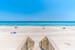 A wooden boardwalk leading to a sandy beach with clear blue water. - Ziggy's Place - New Luxury 8 BR Oceanfront Home; Pool & Elevator! (Surf City)