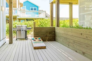 An outdoor deck with a barbecue grill and a ping pong table. - Ziggy's Place - New Luxury 8 BR Oceanfront Home; Pool & Elevator! (Surf City)