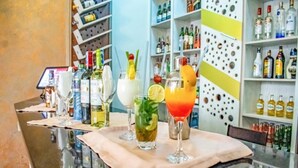A bar area with a variety of liquor bottles and glasses on shelves and the counter. - The Gem Hotel Naivasha (Naivasha)