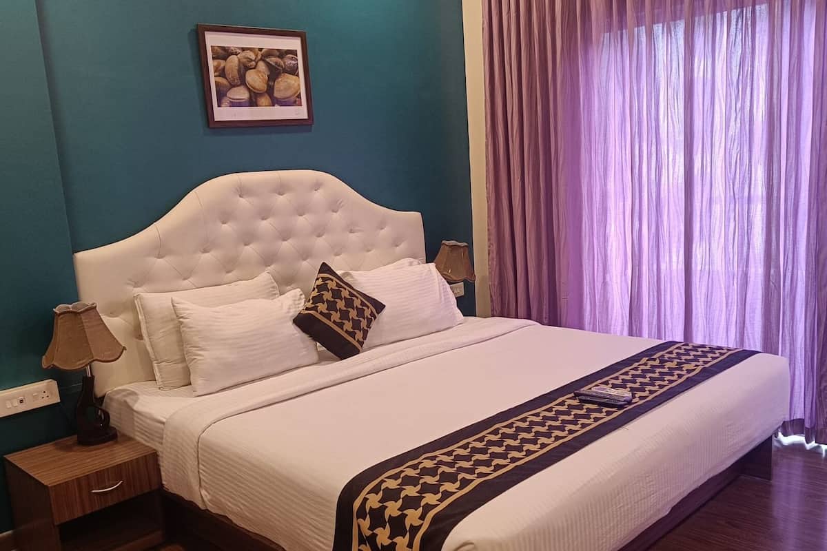 A neatly made bed with a white headboard and a decorative throw blanket.