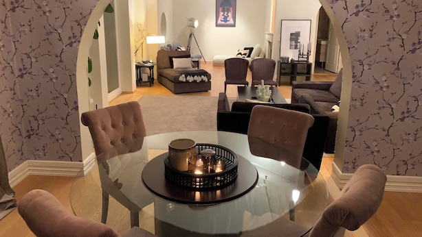 A living room with a glass table, two armchairs, a sofa, and a coffee table with a decorative tray. - Spacious 5-bedroom villa with beautiful panoramic view!! (Buskerud)