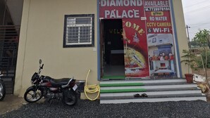 Un edificio de dos pisos con un letrero que dice "HOTEL DIAMOND PALACE".