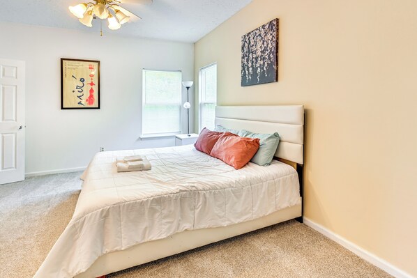 A bedroom with a bed, a nightstand, a lamp, and a window with blinds. - 10 Mi to Keeneland: Family Home w/ Deck & Yard (Lexington)