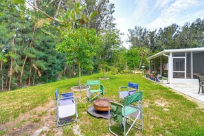 An outdoor patio area with a fire pit, several folding chairs, and a covered seating area. - 3 Mi to Dtwn Sebastian: Home w/ Furnished Patio! (Sebastian)