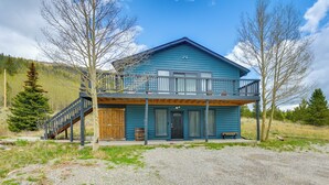 A two-story blue cabin with a wooden staircase, a front porch, and a gravel driveway. - Hike, Fish, Ski & Explore: Cabin Near Breckenridge (Alma)