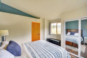 A bedroom with a bed, a bench, a door, and a window. - Hike, Fish, Ski & Explore: Cabin Near Breckenridge (Alma)