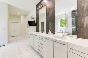 A modern bathroom with a large mirror, two sinks, and a vanity with drawers. - Luxe Buckhead Retreat 6 Mi to Dtwn Atlanta (Atlanta)